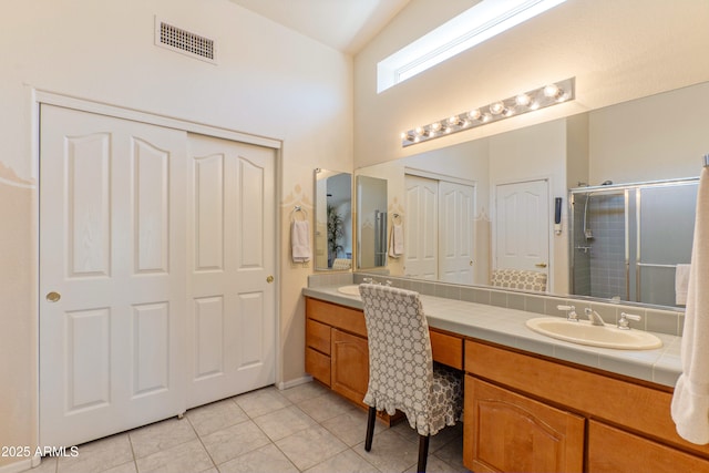 15371 W Piccadilly Rd, Goodyear, AZ 85395 - full bath featuring visible vents, a sink, a shower stall, tile patterned floors, and double vanity