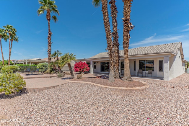 15371 W Piccadilly Rd, Goodyear, AZ 85395 - rear view of house featuring a patio area, stucco siding, and a tiled roof