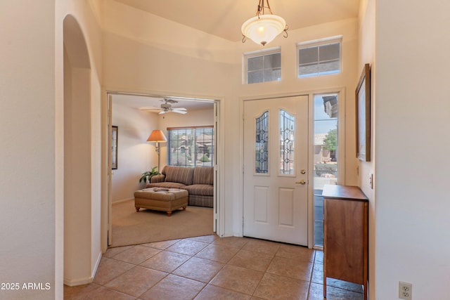 15371 W Piccadilly Rd, Goodyear, AZ 85395 - entryway with ceiling fan, light carpet, baseboards, and light tile patterned floors