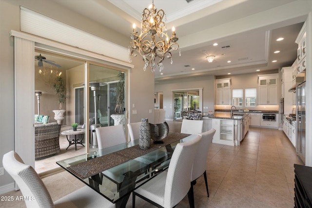 8597 E Arroyo Seco Rd, Scottsdale, AZ 85266 - dining space with a raised ceiling, an inviting chandelier, recessed lighting, ornamental molding, and light tile patterned floors