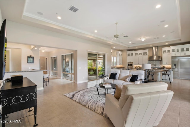 8597 E Arroyo Seco Rd, Scottsdale, AZ 85266 - living area featuring a tray ceiling, light tile patterned flooring, visible vents, and ceiling fan