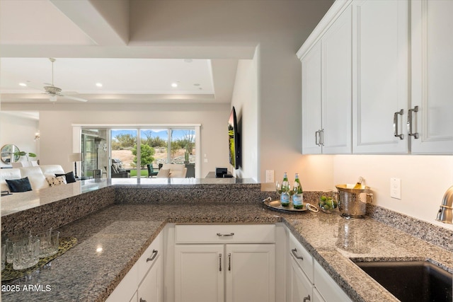 8597 E Arroyo Seco Rd, Scottsdale, AZ 85266 - kitchen featuring a sink, recessed lighting, white cabinetry, a ceiling fan, and stone countertops