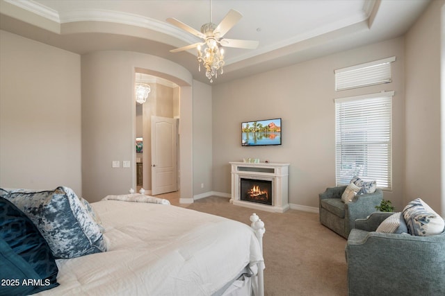 8597 E Arroyo Seco Rd, Scottsdale, AZ 85266 - bedroom with crown molding, arched walkways, light carpet, a lit fireplace, and baseboards
