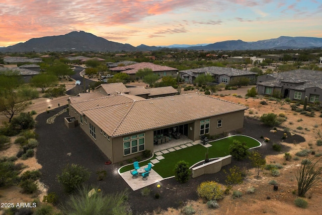 8597 E Arroyo Seco Rd, Scottsdale, AZ 85266 - aerial view at dusk with a residential view and a mountain view