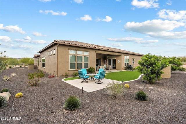 8597 E Arroyo Seco Rd, Scottsdale, AZ 85266 - back of property featuring a patio area, a tiled roof, and stucco siding