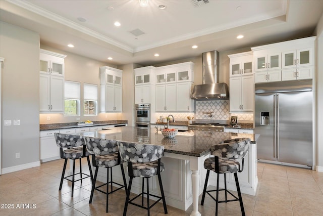 8597 E Arroyo Seco Rd, Scottsdale, AZ 85266 - kitchen with wall chimney exhaust hood, a sink, tasteful backsplash, crown molding, and appliances with stainless steel finishes