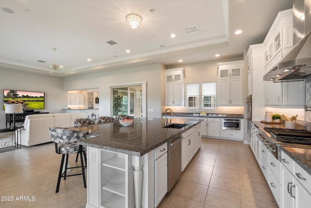 8597 E Arroyo Seco Rd, Scottsdale, AZ 85266 - kitchen featuring a sink, a raised ceiling, appliances with stainless steel finishes, wall chimney range hood, and light tile patterned floors
