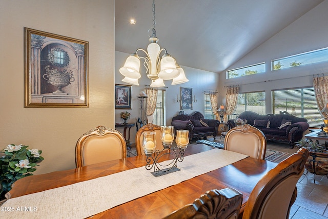 dining room with high vaulted ceiling and a chandelier