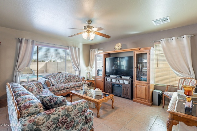 living room featuring light tile patterned floors and ceiling fan