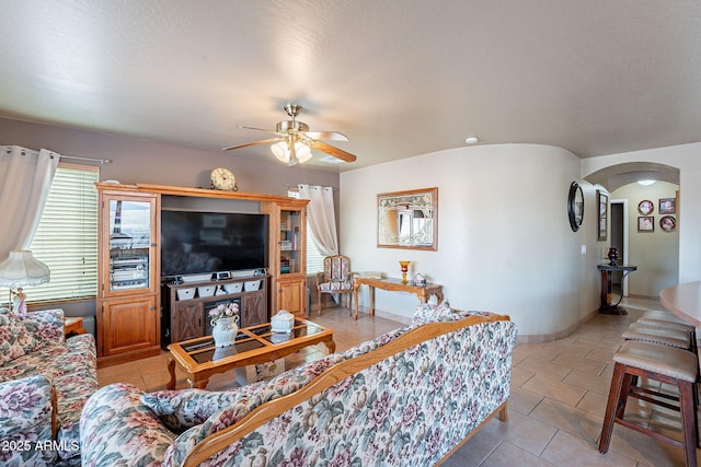 tiled living room featuring ceiling fan