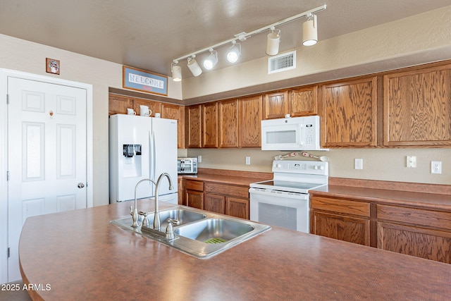 kitchen with sink and white appliances