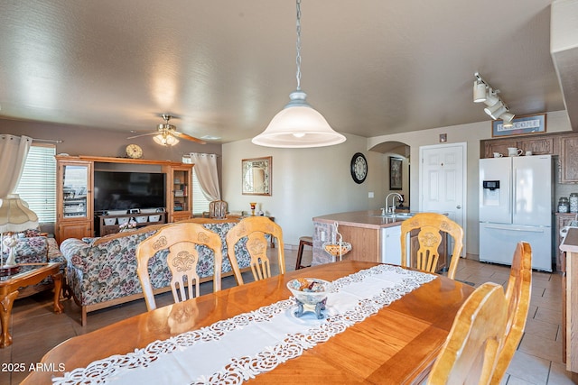 tiled dining room featuring sink and ceiling fan