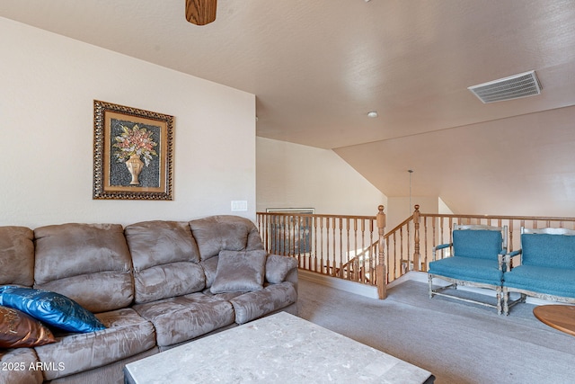 carpeted living room with vaulted ceiling