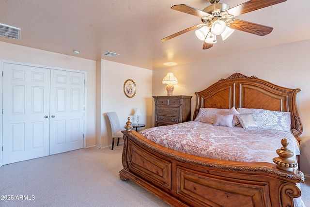 bedroom featuring light colored carpet, ceiling fan, and a closet