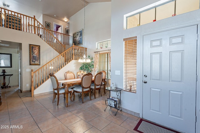 tiled foyer entrance with a towering ceiling