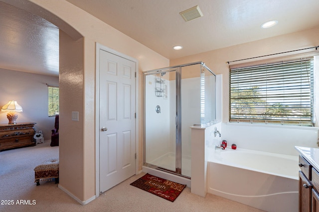 bathroom featuring vanity and separate shower and tub