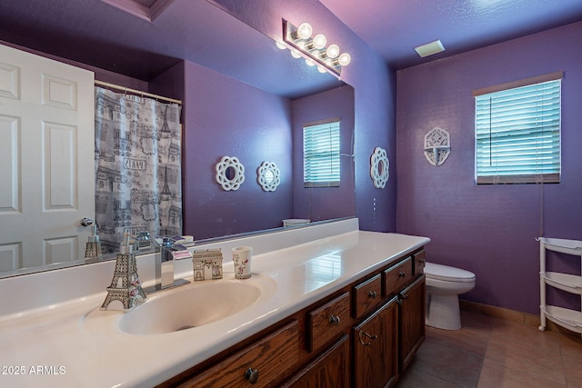 bathroom featuring tile patterned flooring, vanity, and toilet