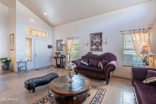 living room with light tile patterned floors, high vaulted ceiling, and a wealth of natural light