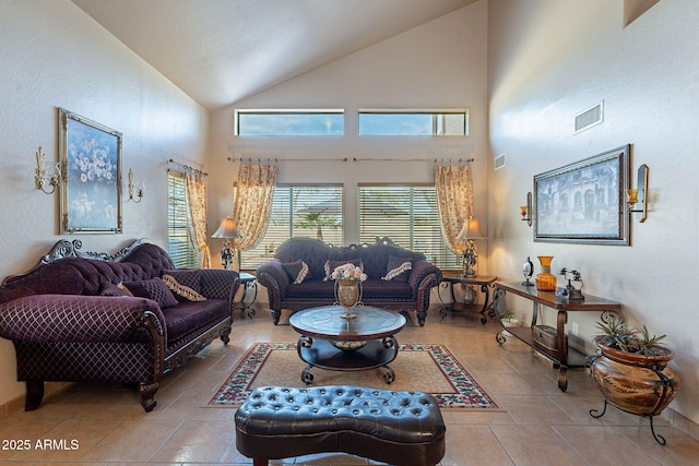 tiled living room featuring vaulted ceiling