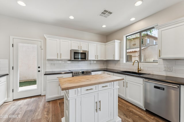 1717 E Joseph Way, Gilbert, AZ 85295 - kitchen with stainless steel appliances, wooden counters, white cabinetry, tasteful backsplash, and recessed lighting
