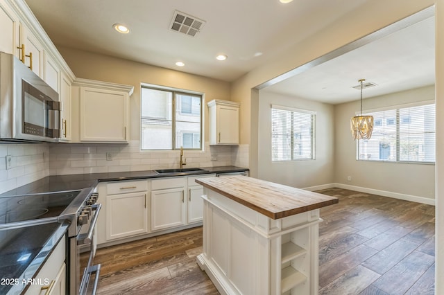 1717 E Joseph Way, Gilbert, AZ 85295 - kitchen featuring appliances with stainless steel finishes, butcher block countertops, a chandelier, dark wood finished floors, and recessed lighting