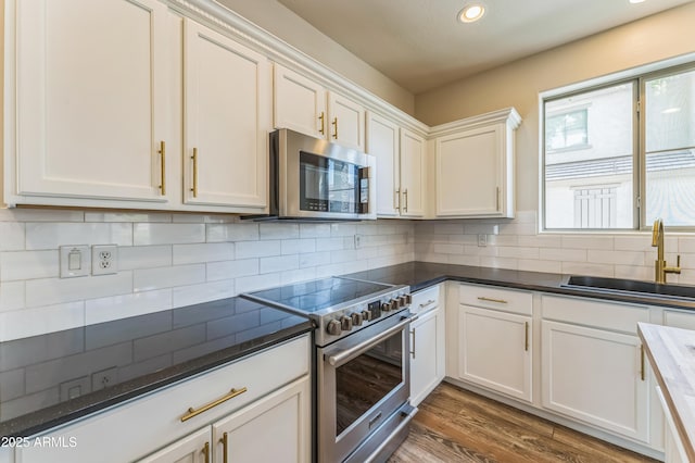 1717 E Joseph Way, Gilbert, AZ 85295 - kitchen featuring appliances with stainless steel finishes, white cabinets, recessed lighting, tasteful backsplash, and wood finished floors