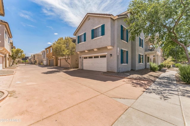 1717 E Joseph Way, Gilbert, AZ 85295 - view of home's exterior featuring stucco siding, driveway, a residential view, and an attached garage