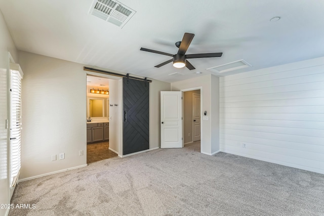 1717 E Joseph Way, Gilbert, AZ 85295 - unfurnished bedroom featuring carpet flooring, a barn door, ensuite bathroom, and a ceiling fan