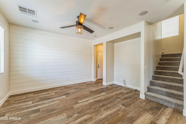 1717 E Joseph Way, Gilbert, AZ 85295 - spare room with wood finished floors, stairs, plenty of natural light, a ceiling fan, and wooden walls
