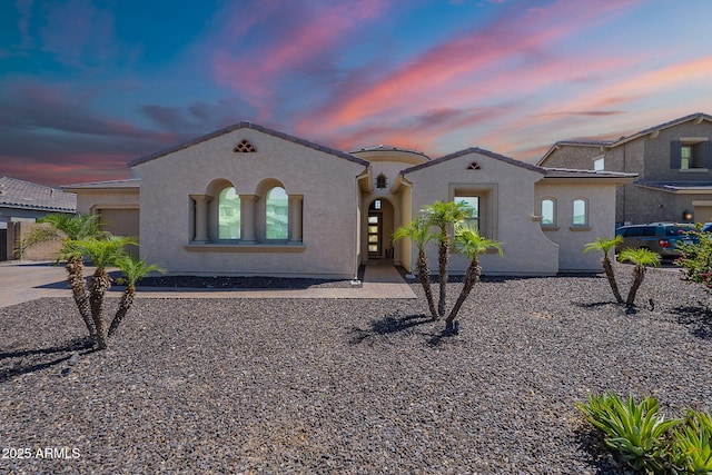 9345 W Robin Ln, Peoria, AZ 85383 - mediterranean / spanish home featuring stucco siding, a garage, concrete driveway, and a tiled roof