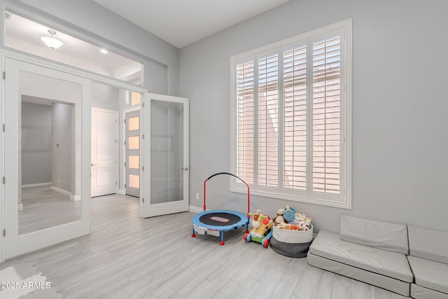 9345 W Robin Ln, Peoria, AZ 85383 - game room featuring french doors, wood finished floors, and baseboards