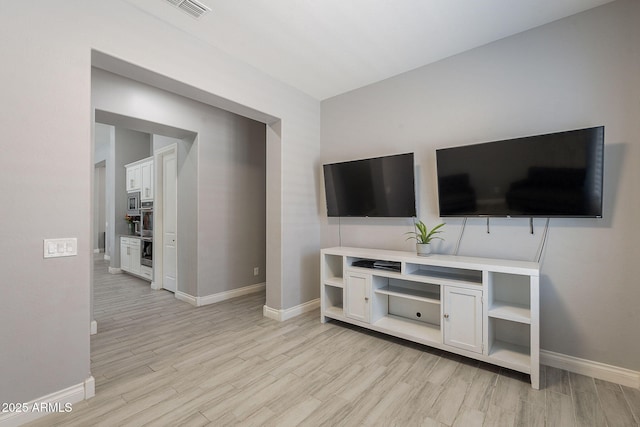 9345 W Robin Ln, Peoria, AZ 85383 - unfurnished living room with baseboards and light wood-type flooring