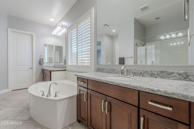 9345 W Robin Ln, Peoria, AZ 85383 - bathroom with a bath, a walk in shower, tile patterned floors, and vanity
