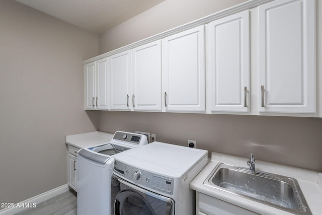 9345 W Robin Ln, Peoria, AZ 85383 - laundry area with cabinet space, washing machine and dryer, baseboards, and light wood finished floors