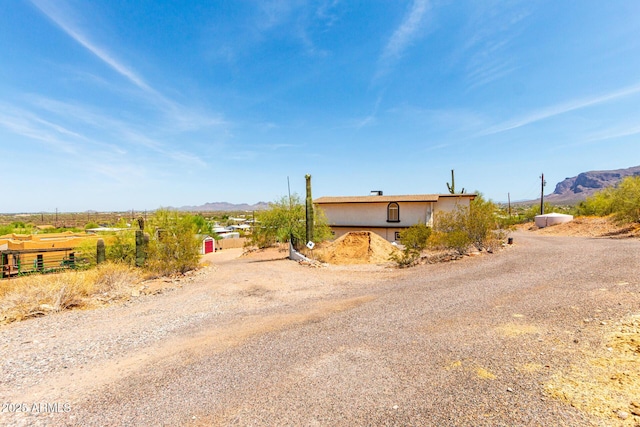 5484 E 36th Ave, Apache Junction, AZ 85119 - view of front of home with a mountain view, dirt driveway, and stucco siding