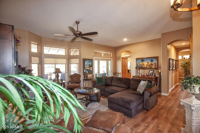 living room featuring wood-type flooring and ceiling fan