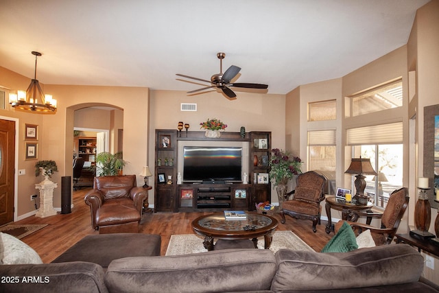 living room featuring ceiling fan with notable chandelier and hardwood / wood-style flooring