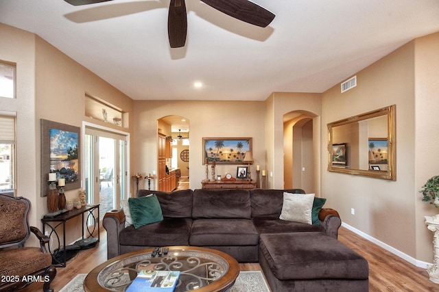 living room featuring ceiling fan and wood-type flooring