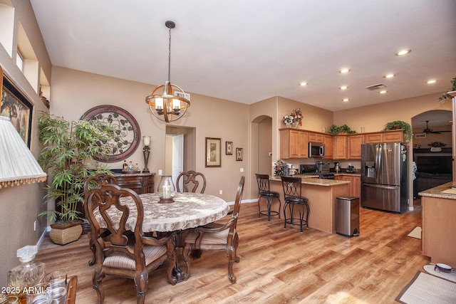 dining room with an inviting chandelier and light wood-type flooring