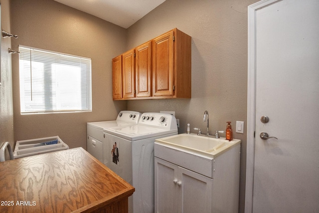 washroom with separate washer and dryer, cabinets, and sink