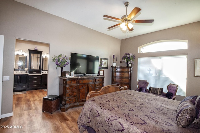 bedroom featuring ensuite bathroom, hardwood / wood-style floors, and ceiling fan