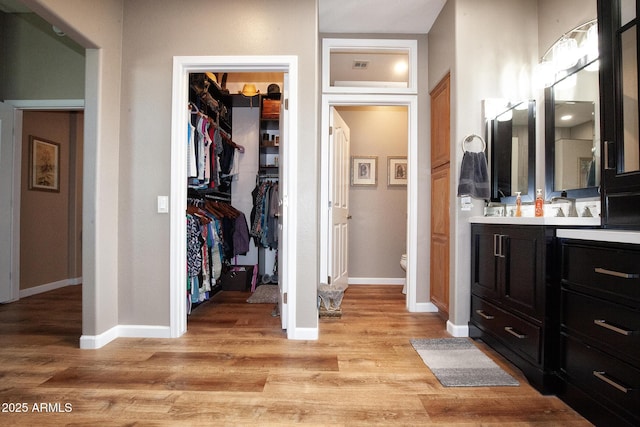 bathroom with toilet, hardwood / wood-style flooring, and vanity