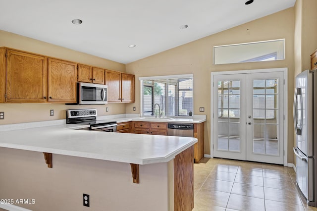 625 W Douglas Ave, Gilbert, AZ 85233 - kitchen featuring appliances with stainless steel finishes, lofted ceiling, french doors, a peninsula, and a kitchen breakfast bar