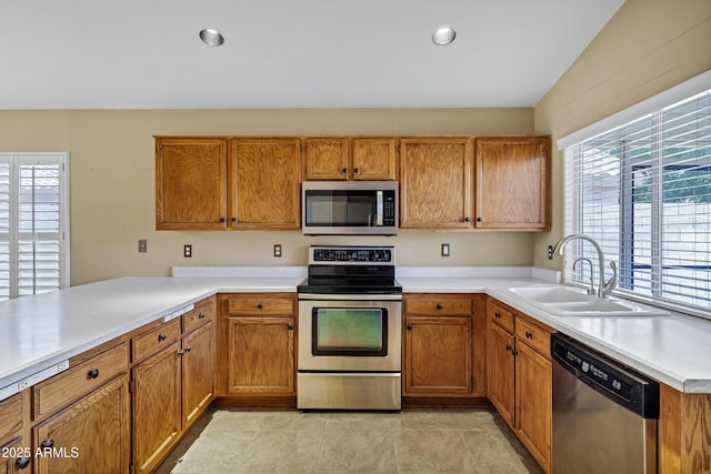 625 W Douglas Ave, Gilbert, AZ 85233 - kitchen with stainless steel appliances, light countertops, brown cabinets, and recessed lighting