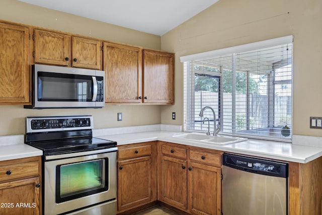 625 W Douglas Ave, Gilbert, AZ 85233 - kitchen with stainless steel appliances, light countertops, brown cabinets, and vaulted ceiling