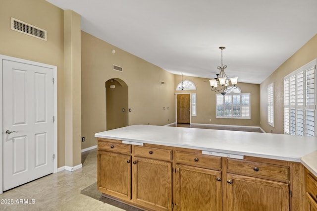 625 W Douglas Ave, Gilbert, AZ 85233 - kitchen with arched walkways, lofted ceiling, a peninsula, a chandelier, and light countertops