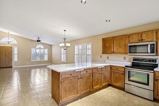 625 W Douglas Ave, Gilbert, AZ 85233 - kitchen with stainless steel appliances, a chandelier, a peninsula, light countertops, and brown cabinets