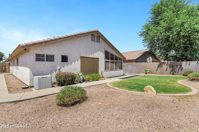 625 W Douglas Ave, Gilbert, AZ 85233 - back of property with stucco siding, a fenced backyard, a sunroom, and a tiled roof