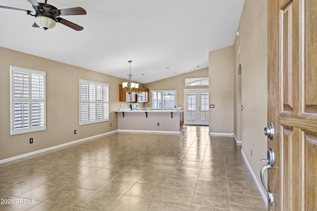625 W Douglas Ave, Gilbert, AZ 85233 - unfurnished living room with vaulted ceiling, a chandelier, light tile patterned floors, and a ceiling fan
