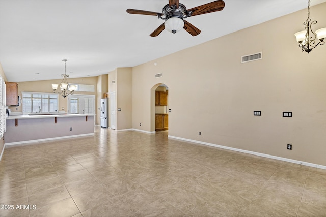625 W Douglas Ave, Gilbert, AZ 85233 - unfurnished living room featuring a chandelier, arched walkways, vaulted ceiling, and ceiling fan